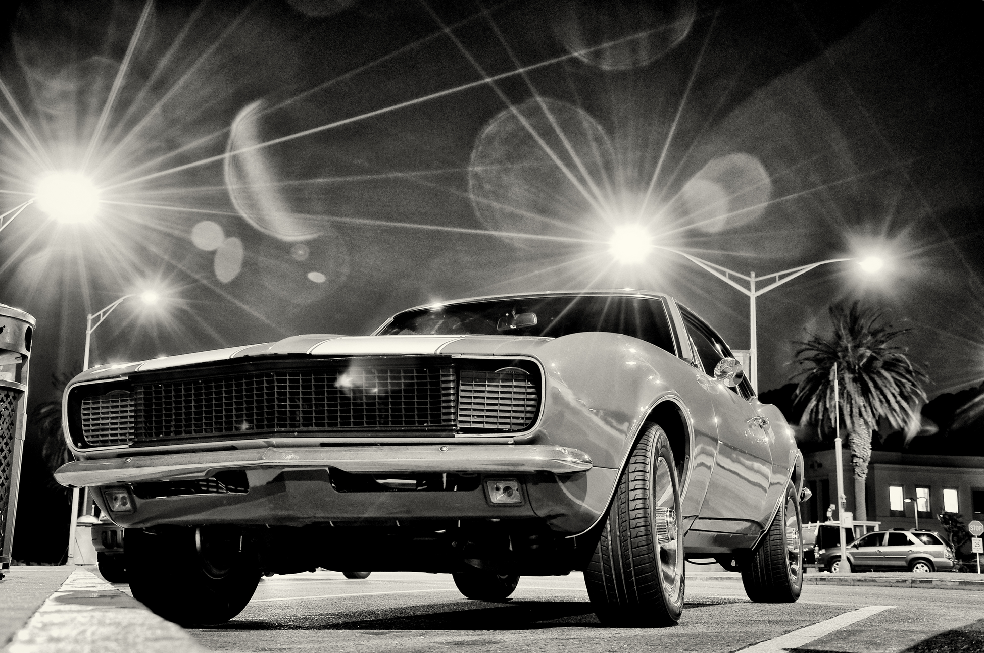vintage muscle car in gray with streetlights on 