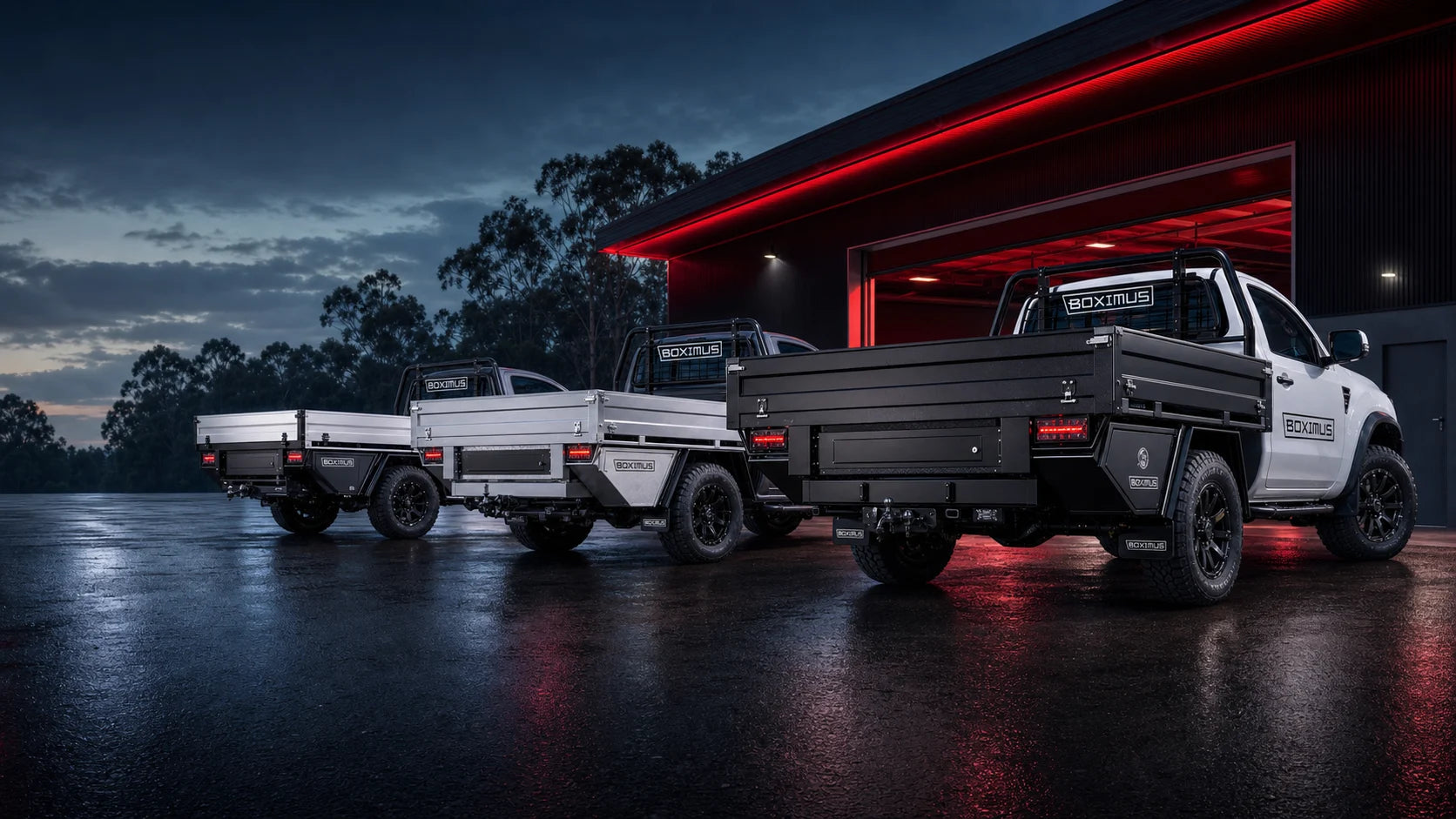 Boximus tray-back utes outside a modern workshop